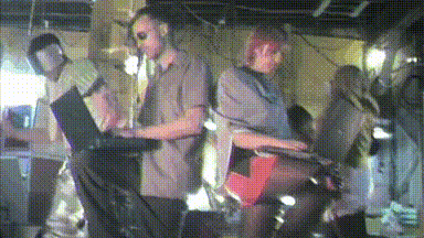 two hackers got one leg up with a laptop on it, look at each other in determined approval: 'HACK THE PLANET' flashes on the screen in cyber-stylized text